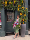 Woman holding flower bouquet.