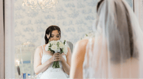 bride smelling flower bouquet designed by j morris flowers