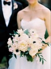 bride and groom, bride holding white and pink wedding flowers from j morris flowers