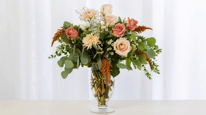 Fall flower bouquet with roses and peonies and green accents