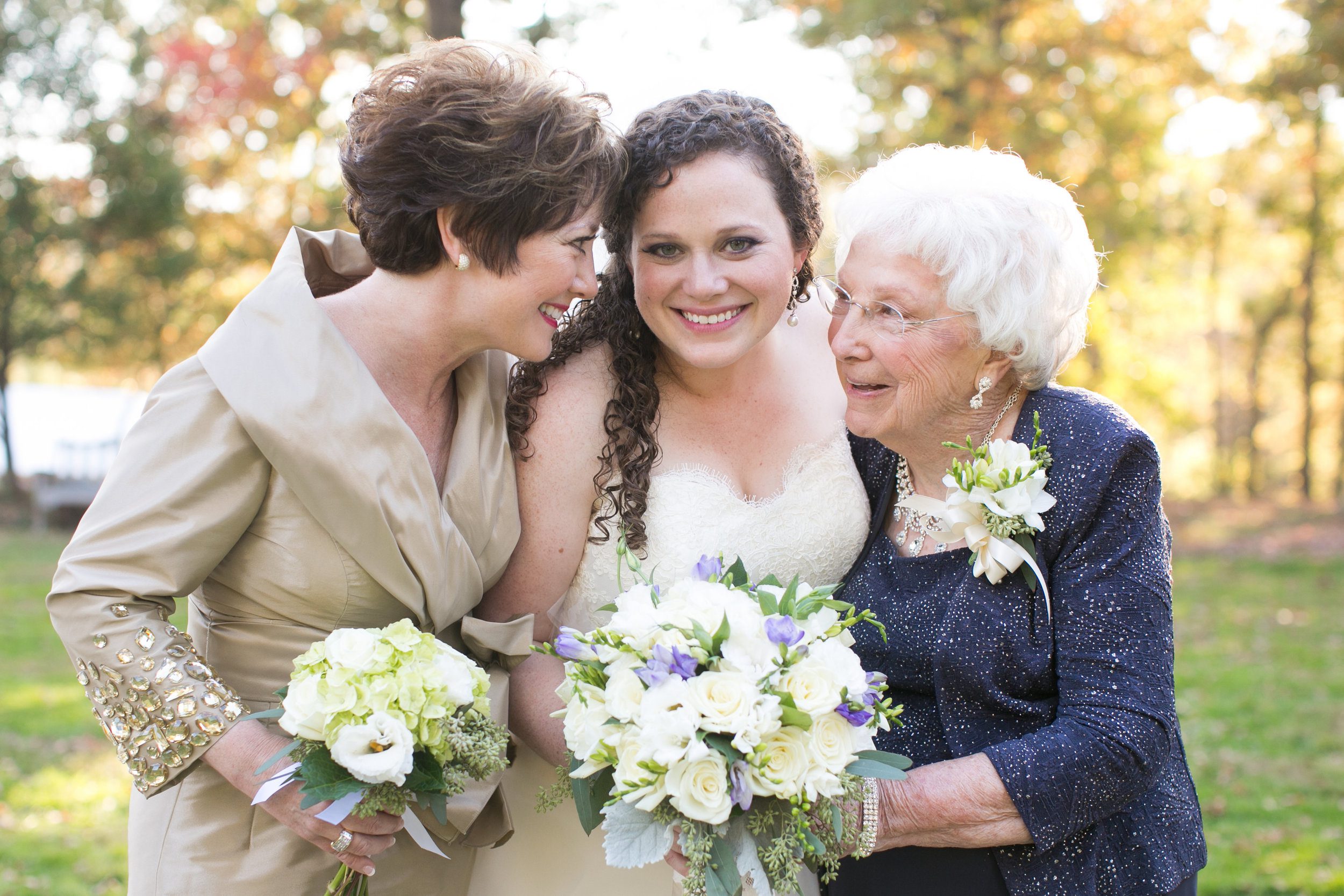 Love this shot of mom, bride and grandmother, each with their own floral accessory. &nbsp;The bride's bouquet has just a touch of soft purple with sage greens and gray accents to bring in a bit of the season.&nbsp;