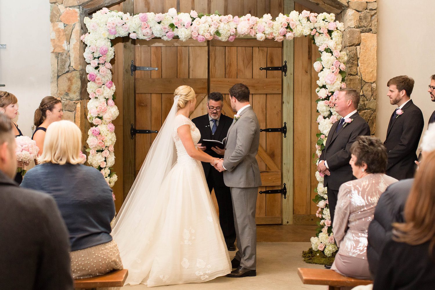 Full floral arch with Peonies, Hydrangea and Garden Roses at Stone Tower Winery. Photography by Candice Adelle.
