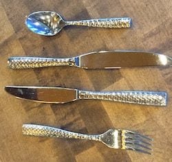 Gold and silver cutlery adds visual interest.&nbsp;