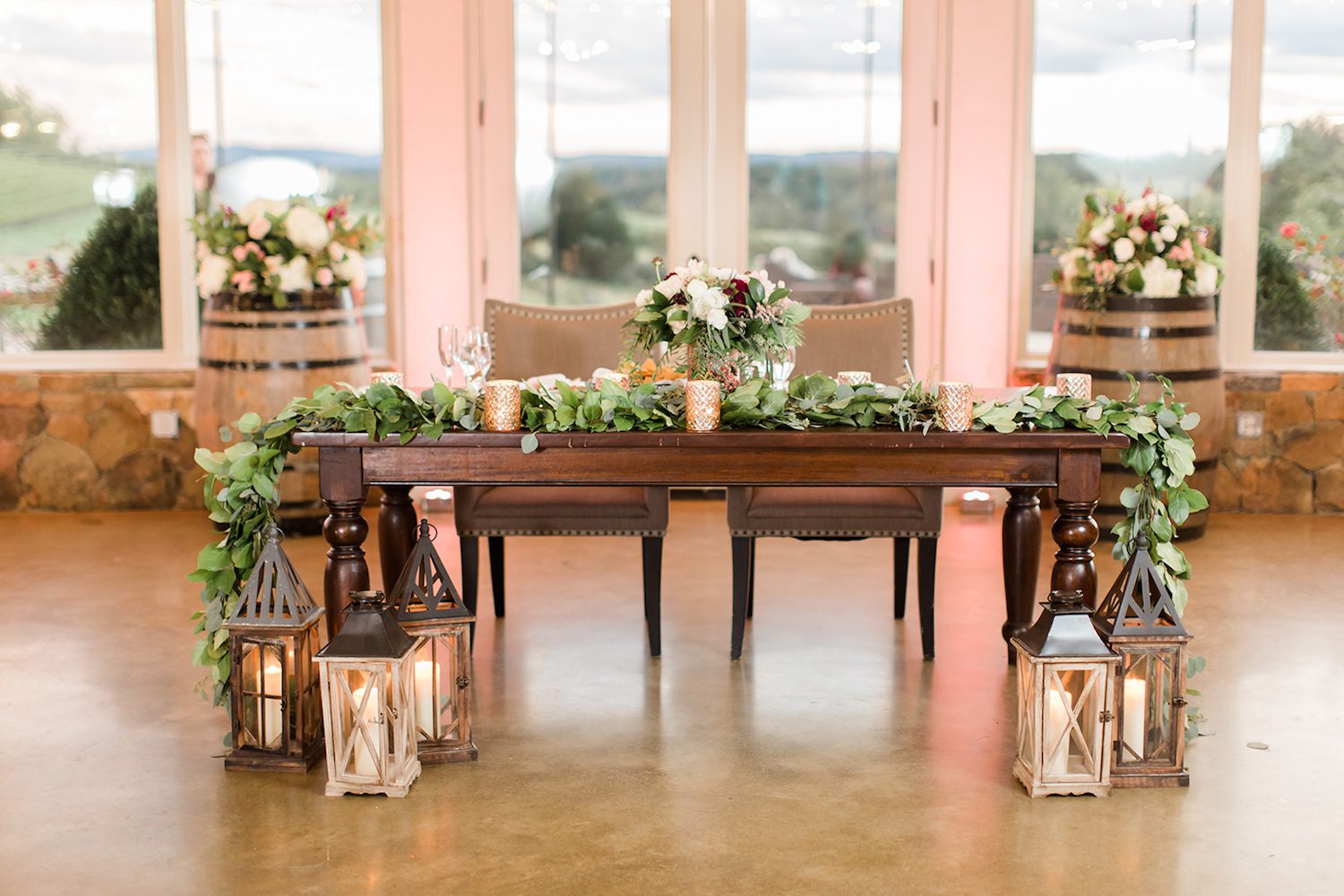 Candice Adelle Photography at Stone Tower Winery in Leesburg, Virginia. Lanterns framed by garland with the bride’s bouquet in the center.