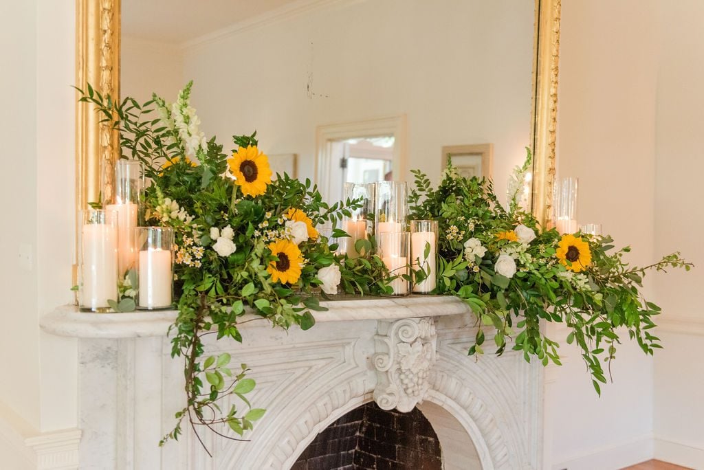 Emily Alyssa Photography took this image of a Sunflower laden mantle at Rust Manor House.