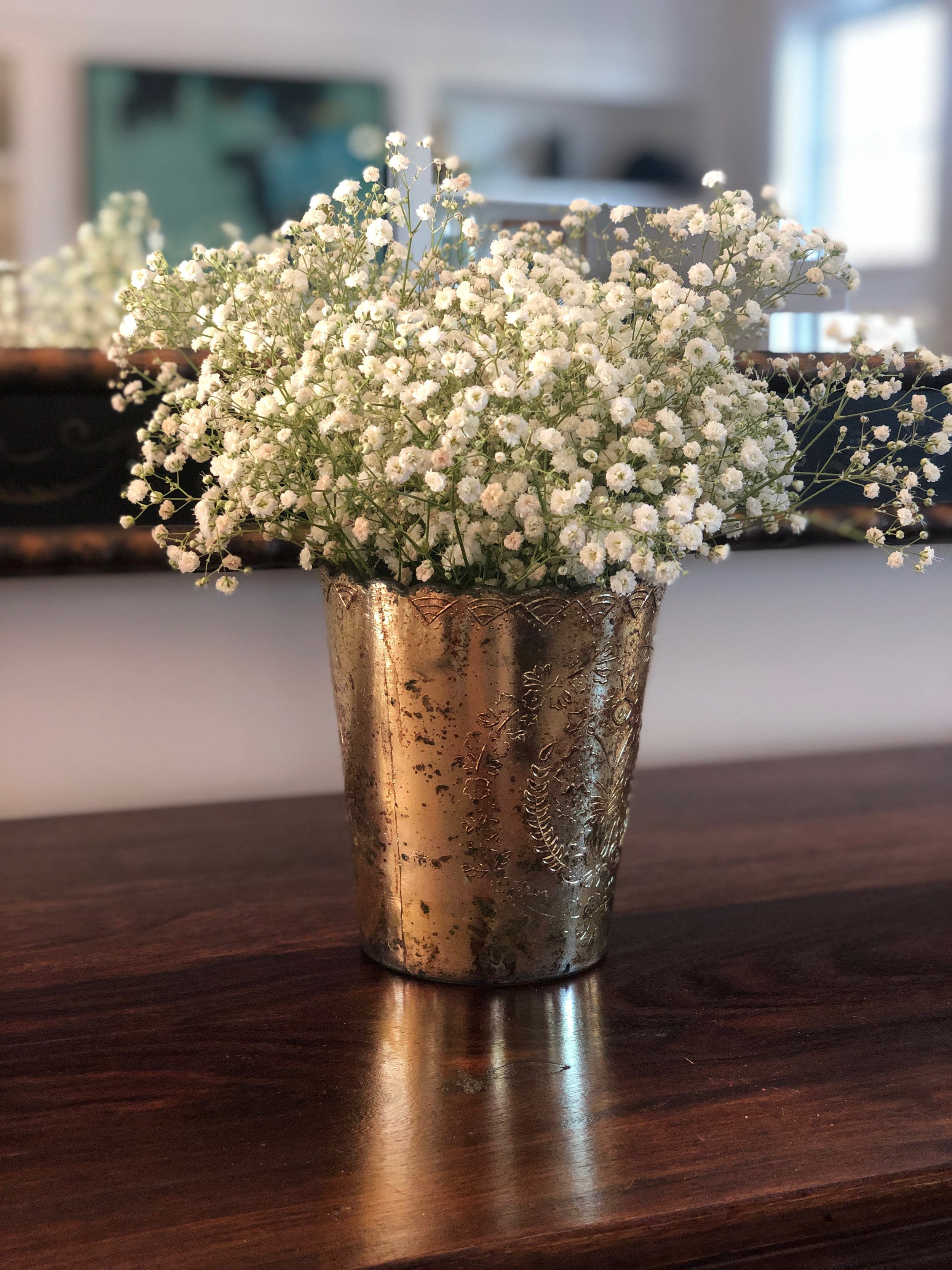 Babies Breath arranged in a gold vase from our wedding collection.