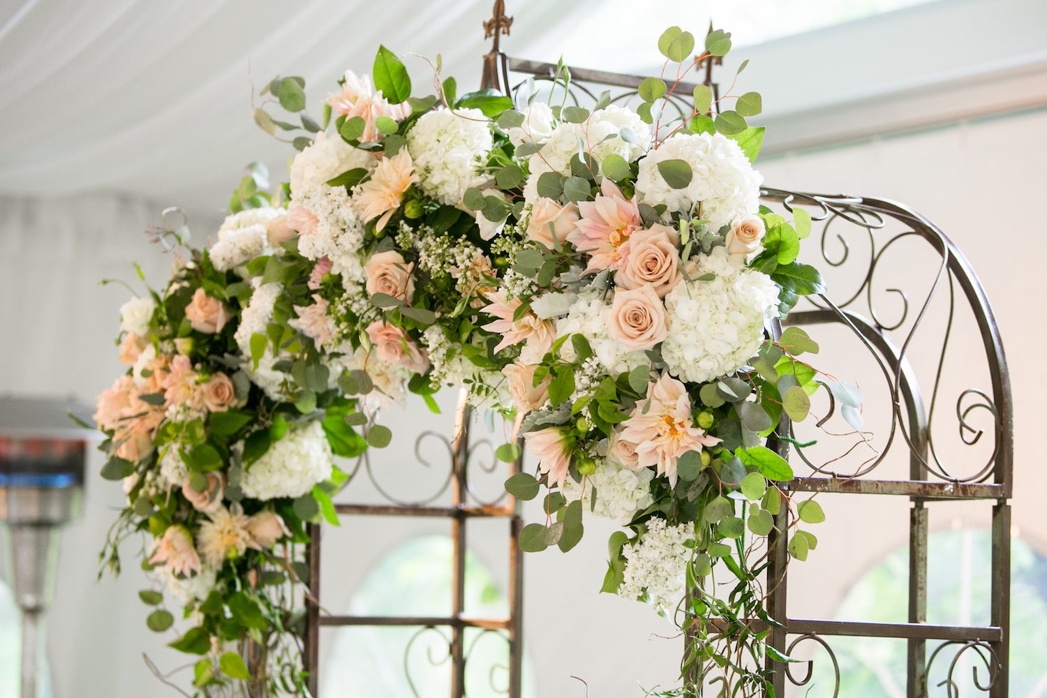 Arch flowers include Cafe Au Lait Dahlia, Quicksand Roses, White Lilac and Hydrangea, Dusty Miller, Silver Dollar Eucalyptus and Jasmine.