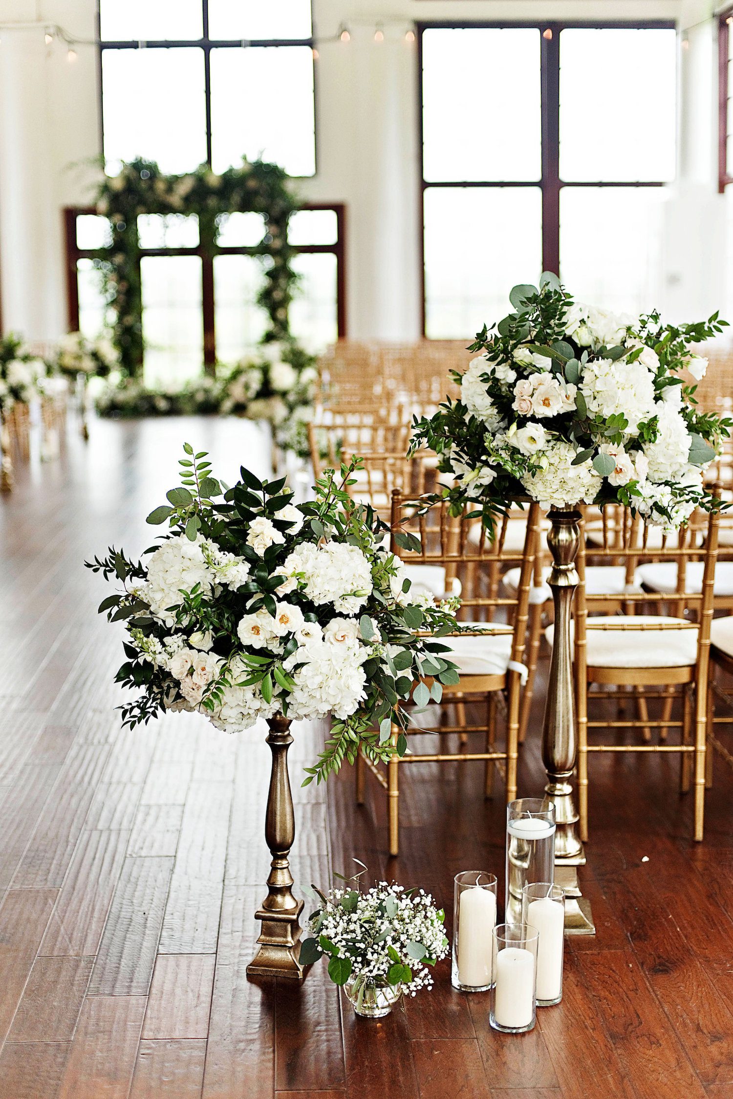 Re-purposed centerpieces helped to add the missing garden element to this inside ceremony planned for the outdoors. Photography by the Photography Smiths at Raspberry Plain Manor.