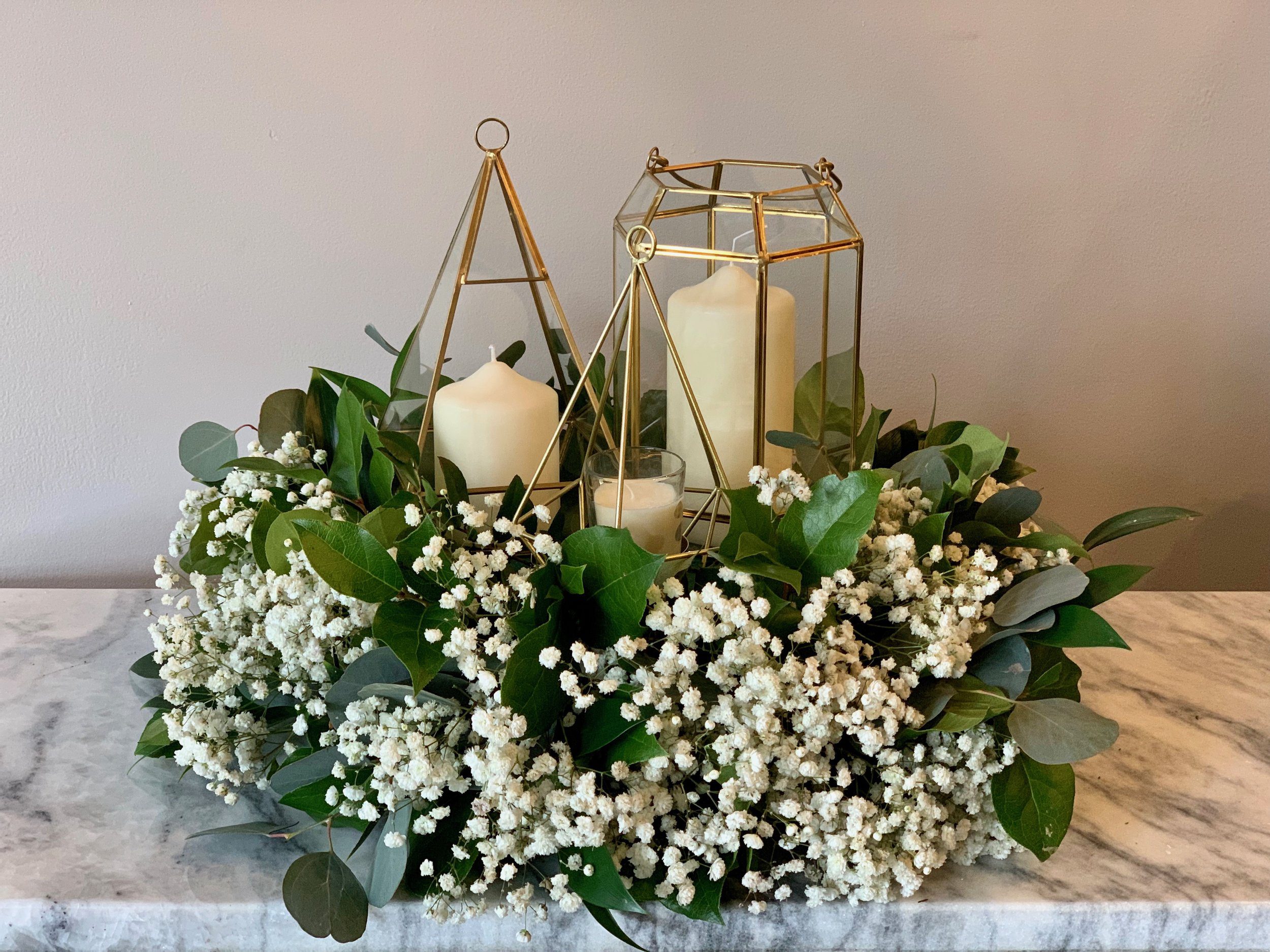 Geo lanterns and candles in a wreath.