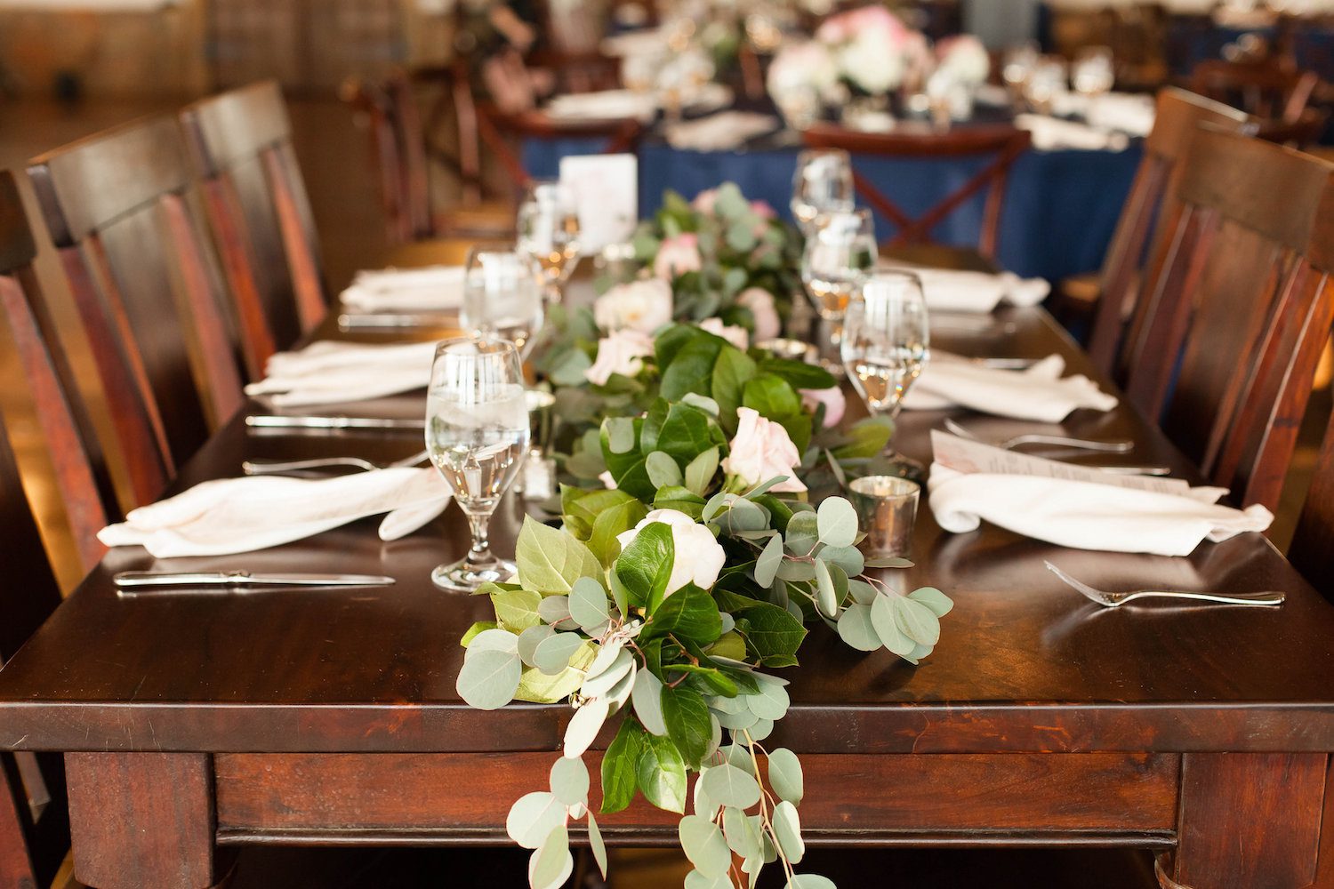 Garland on wooden farmhouse tables at Stone Tower Winery, Leesburg, Virginia. Photography by Candice Adelle.