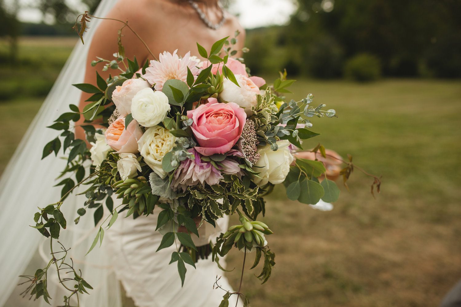 Jennifer loves the Ranunculus, Zinnia, Garden Roses and Rice Flower in the bouquet. Photography by Carly Romeo + Co.