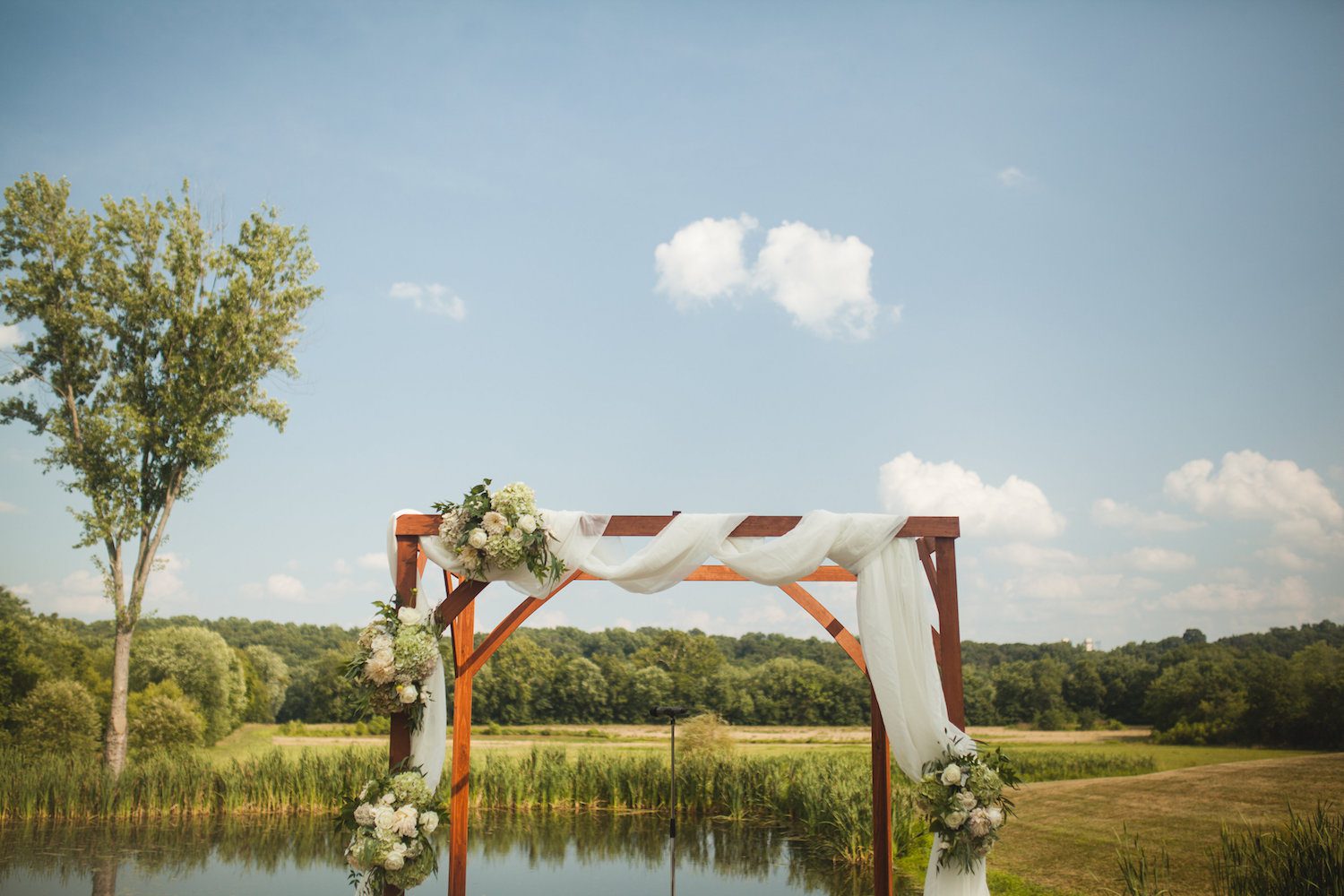 A friend of Danielle's father built the Chuppah that featured cascading flower bundles. Photography by Carly Romeo + Co.