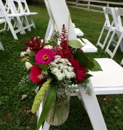 Summer bloom arrangements on outdoor chairs can be moved inside.