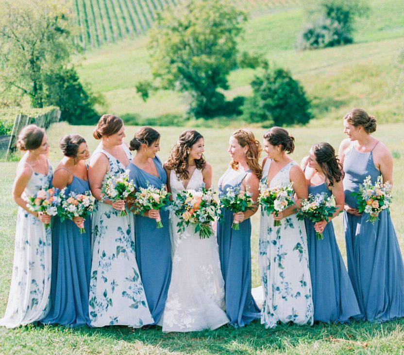 bridal party standing with flowers in hand